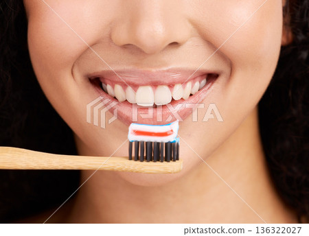Smile, wood toothbrush and studio closeup for dental wellness, woman and healthy mouth by pink background. Girl, model and natural toothpaste for teeth whitening, results and sustainable product Smile, wood toothbrush and studio closeup for dental wellness, woman and healthy mouth by pink background. Girl, model and natural toothpaste for teeth whitening, results and sustainable product 136322027