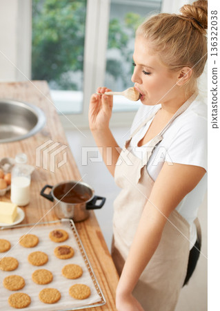 Woman, taste or baker baking cookies with dough or pastry pot in a bakery kitchen with a dessert recipe. Food business, start or girl chef cooking in preparation of a sweet meal, cake or biscuits 136322038