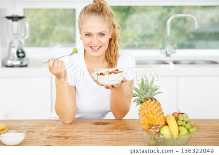 Fruits, eating or portrait of happy woman with healthy lunch or breakfast meal or diet in kitchen at home. Morning, smile or vegan girl enjoying a salad, food or bowl to lose weight for wellness Fruits, eating or portrait of happy woman with healthy lunch or breakfast meal or diet in kitchen at home. Morning, smile or vegan girl enjoying a salad, food or bowl to lose weight for wellness 136322049
