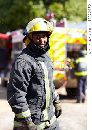 Safety, hero and portrait of a black man as a firefighter for service, fire emergency and working. Job, professional and an African fireman in a uniform for security, rescue and fearless career Safety, hero and portrait of a black man as a firefighter for service, fire emergency and working. Job, professional and an African fireman in a uniform for security, rescue and fearless career 136322070