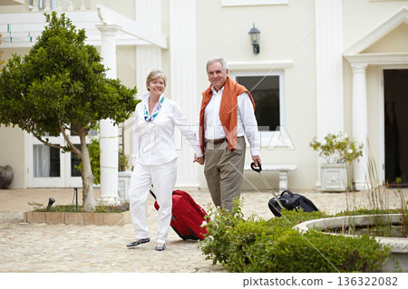 Travel, hotel and happy senior couple walking with suitcase in a holiday or vacation location in retirement together. Bag, smile and elderly people on a journey or man and woman walk in happiness Travel, hotel and happy senior couple walking with suitcase in a holiday or vacation location in retirement together. Bag, smile and elderly people on a journey or man and woman walk in happiness 136322082