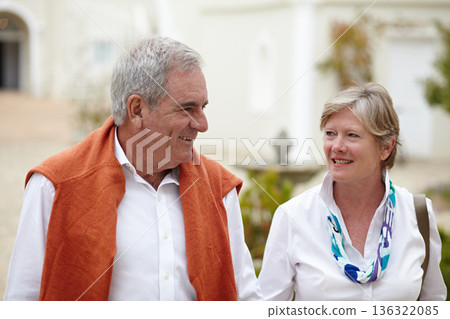 Smile, conversation and a senior couple in the city for a retirement holiday, travel and happiness. Happy, love and an elderly man and woman walking in an old town or hotel during a vacation together 136322085