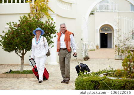 Hotel, vacation and elderly couple walking with suitcase in a holiday location happy in retirement and travel together. Bag, smile and senior people on a journey or man and woman walk in happiness Hotel, vacation and elderly couple walking with suitcase in a holiday location happy in retirement and travel together. Bag, smile and senior people on a journey or man and woman walk in happiness 136322086