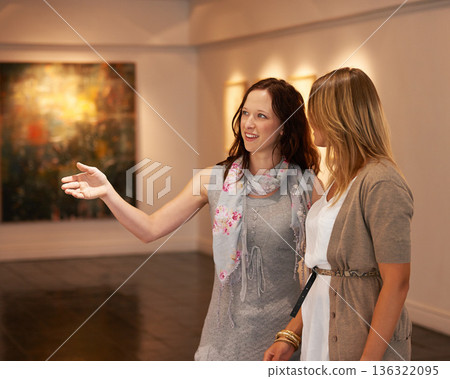 Museum, exhibition and a woman friends in an art gallery, looking at photography in creative appreciation. Painting, design or culture with an attractive young female and friend at an artwork exhibit Museum, exhibition and a woman friends in an art gallery, looking at photography in creative appreciation. Painting, design or culture with an attractive young female and friend at an artwork exhibit 136322095