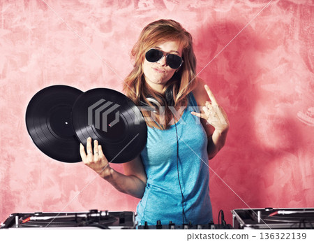 DJ woman, mixer and portrait with vinyl records, sunglasses and horns sign at club, studio or party. Girl, music director and party with rock icon, turntable or attitude for event, celebration or job 136322139