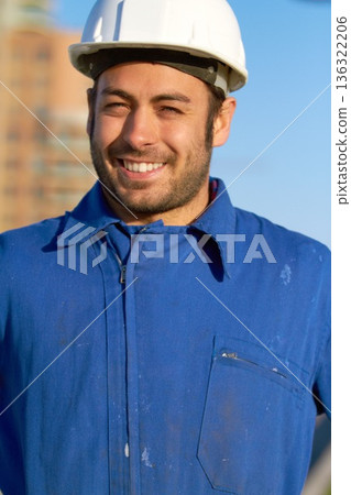 Happy man, architect and portrait smile for construction, building or industrial architecture in the city. Male person, engineer or contractor smiling with hard hat for safety in maintenance on site Happy man, architect and portrait smile for construction, building or industrial architecture in the city. Male person, engineer or contractor smiling with hard hat for safety in maintenance on site 136322206