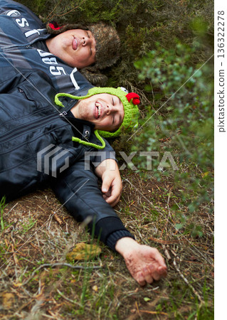 Drunk, hangover and boys with friends sleeping outdoor on a field together in the morning after a party. Grass, tired or alcoholism with a plus size man and friend asleep on the ground in a park 136322278