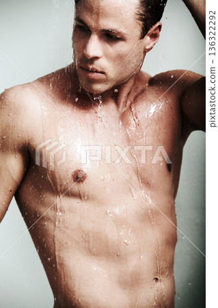 Sexy, shower and body of man with water for washing, cleaning and skincare or wellness. Seductive male model person posing for fitness, grooming and hygiene for clean or healthy skin with self care Sexy, shower and body of man with water for washing, cleaning and skincare or wellness. Seductive male model person posing for fitness, grooming and hygiene for clean or healthy skin with self care 136322292