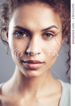 Beauty, face and portrait of woman in studio confident, beautiful and gorgeous on gray background. Salon, attractive and closeup of female person with natural makeup, cosmetics and curly hairstyle 136322295