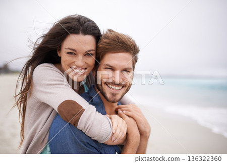 Couple on beach, portrait and hug with travel and holiday, love and care with trust and happiness. Freedom, mockup space and happy man with woman outdoor, summer vacation and ocean with support 136322360