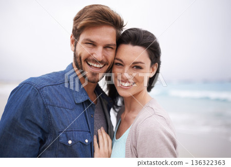 Portrait, hug and couple at a beach with love for travel, romance and freedom together outdoors. Face, smile and happy woman embracing man on trip, vacation or holiday, bond and having fun in Cancun 136322363
