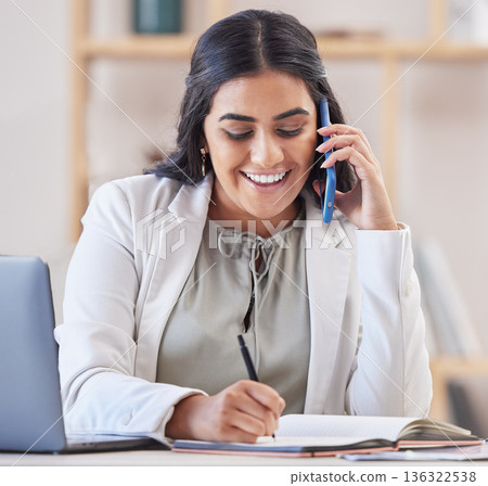 Business woman, phone call and writing in office for networking, schedule and communication. Happy indian female worker talking on smartphone, planning agenda and calendar administration in notebook Business woman, phone call and writing in office for networking, schedule and communication. Happy indian female worker talking on smartphone, planning agenda and calendar administration in notebook 136322538
