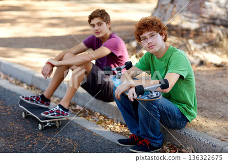 Happy, skateboarding and portrait of friends in the street for sports, hobby and recreation. Nature, happiness and kids with a skateboard in a park or neighborhood road for skating and weekend fun 136322675
