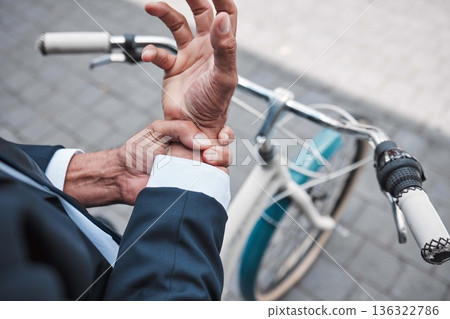 Wrist pain, hands and city business person with anatomy injury, hurt bone fracture and on urban bike travel. Trauma accident, morning bicycle commute and closeup worker with arthritis risk emergency Wrist pain, hands and city business person with anatomy injury, hurt bone fracture and on urban bike travel. Trauma accident, morning bicycle commute and closeup worker with arthritis risk emergency 136322786
