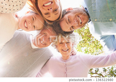 Faces portrait, circle and happy family hug, grandparents and parents bonding with kid child in nature park. Care, solidarity or below view of people smile for natural sunshine, love support or peace 136322980