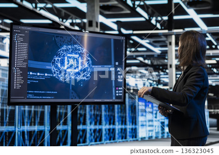 Artificial intelligence AR visualization used by server hub programmer to do gear maintenance. Female engineer monitoring AI neural network data center rigs with display, holographic VFX compositing 136323045