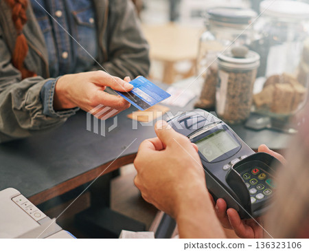 Credit card, debit machine and customer in cafe with hands of cashier for shopping, point of sale and checkout. Payment technology, bills and closeup of person paying for finance in restaurant store 136323106
