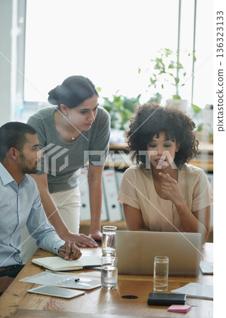 Meeting, laptop and business people in discussion in the office planning a project together. Technology, teamwork and professional web designers working in collaboration with a computer in workplace. 136323133
