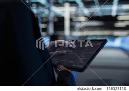 Close up of tablet used by data center computer scientist to write code, updating infrastructure network systems. Server hub worker typing on touchscreen device, coding upgrades Close up of tablet used by data center computer scientist to write code, updating infrastructure network systems. Server hub worker typing on touchscreen device, coding upgrades 136323138