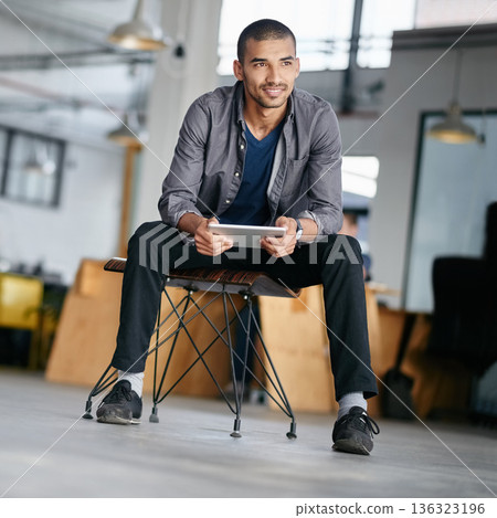 Tablet, thinking and a man designer sitting in his for a creative idea or inspiration while searching online. Technology, research and design with a young male employee using the internet at work 136323196