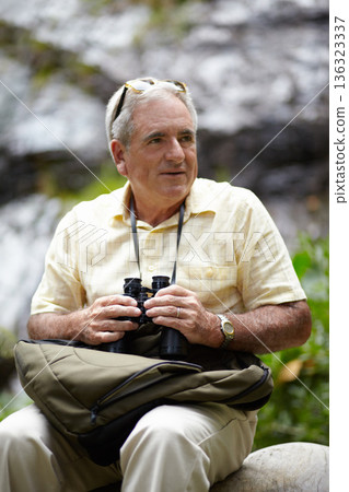 Binoculars, thinking and man in forest or mountains for travel, journey or outdoor adventure and carbon footprint tourism. Senior person with birdwatching experience, search nature or eco environment Binoculars, thinking and man in forest or mountains for travel, journey or outdoor adventure and carbon footprint tourism. Senior person with birdwatching experience, search nature or eco environment 136323337