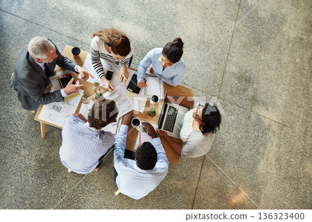 Top view, staff and group brainstorming, teamwork or collaboration with ideas, discussion or planning. Business people, men or women in a modern office, paperwork or laptop with partnership or growth Top view, staff and group brainstorming, teamwork or collaboration with ideas, discussion or planning. Business people, men or women in a modern office, paperwork or laptop with partnership or growth 136323400