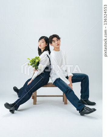 Portrait of a young man and woman wearing denim Portrait of a young man and woman wearing denim 136324553