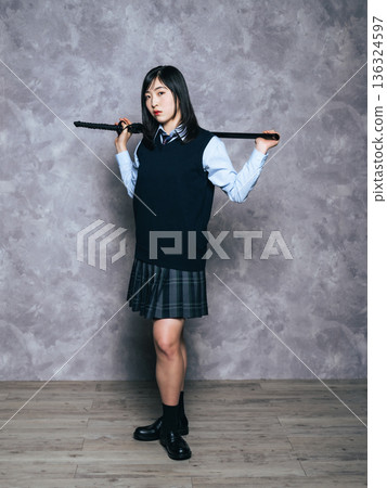 Portrait of a female student holding a Japanese sword Portrait of a female student holding a Japanese sword 136324597
