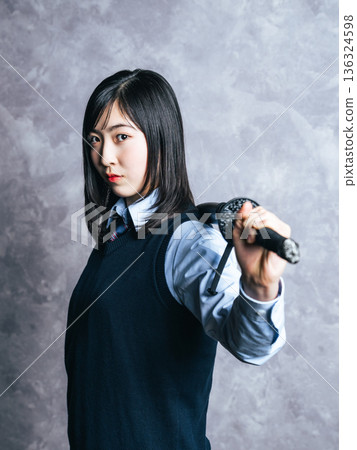 Portrait of a female student holding a Japanese sword Portrait of a female student holding a Japanese sword 136324598