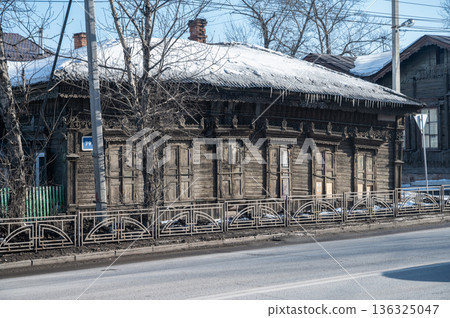 An old unique wooden house in Irkutsk the largest city of Irkutsk Oblast, Russia. The city centre was included in the preliminary list of UNESCO Cultural Heritage Sites. An old unique wooden house in Irkutsk the largest city of Irkutsk Oblast, Russia. The city centre was included in the preliminary list of UNESCO Cultural Heritage Sites. 136325047