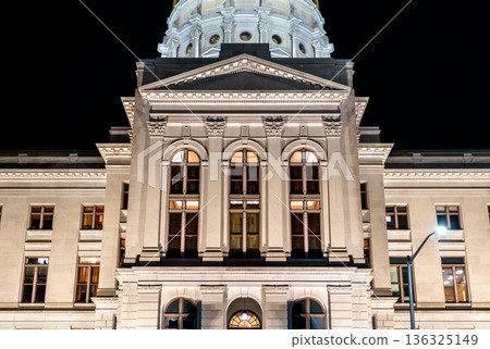 Georgia State Capitol in Atlanta. Illuminated Neoclassical architecture features the stone facade, arched windows and dome base at night Georgia State Capitol in Atlanta. Illuminated Neoclassical architecture features the stone facade, arched windows and dome base at night 136325149