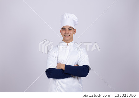 Confident chef standing with arms crossed in uniform Confident chef standing with arms crossed in uniform 136325390