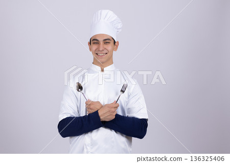 Proud male chef in white uniform crossing his arms Proud male chef in white uniform crossing his arms 136325406