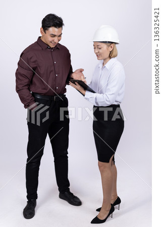 Female engineer and male architect working with documents Female engineer and male architect working with documents 136325421