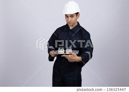 Engineer in hardhat holding glass jars for inspection Engineer in hardhat holding glass jars for inspection 136325447