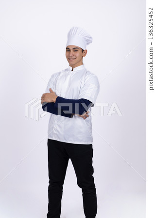 Chef in white uniform looking at camera with confidence Chef in white uniform looking at camera with confidence 136325452