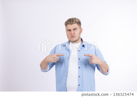 Happy young man pointing fingers at himself with pride 136325474
