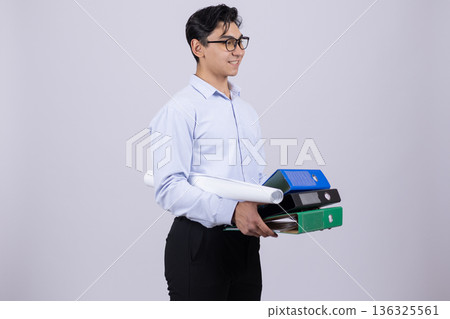 Businessman in white shirt holding stack of office folders Businessman in white shirt holding stack of office folders 136325561