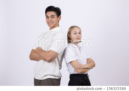 Young students standing back to back in uniform 136325580