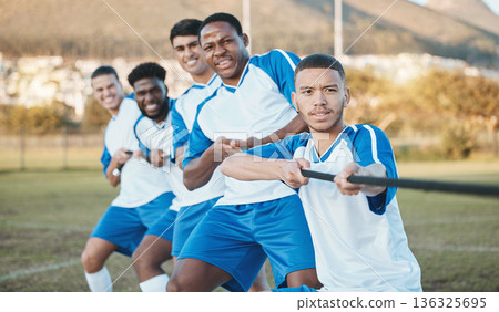 Soccer player, men and tug of war on field with teamwork, strong and muscle, fitness and competition challenge. Male athlete group, football training and diversity, trust and team building in sports Soccer player, men and tug of war on field with teamwork, strong and muscle, fitness and competition challenge. Male athlete group, football training and diversity, trust and team building in sports 136325695