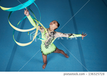 Dance, rhythmic gymnastics and woman in gym with ribbon in air, action with performance top view and fitness. Competition, athlete and female gymnast, creativity and art, routine and energy at arena Dance, rhythmic gymnastics and woman in gym with ribbon in air, action with performance top view and fitness. Competition, athlete and female gymnast, creativity and art, routine and energy at arena 136325728