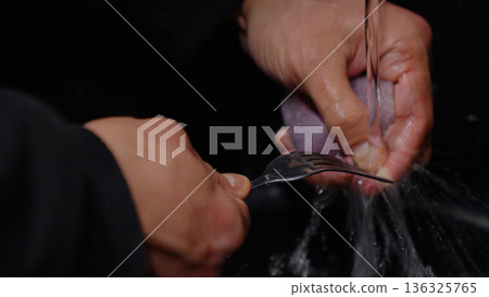 Close up of hands preparing food in the kitchen 136325765