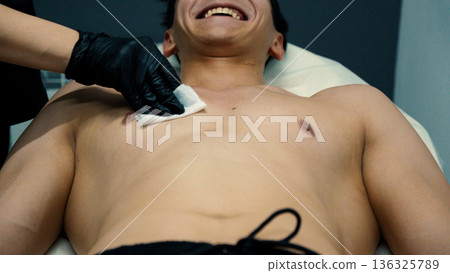 Man undergoing professional laser epilation on chest area Man undergoing professional laser epilation on chest area 136325789