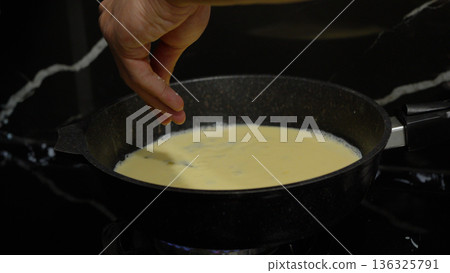 Close up of cooking process with milk in a pan Close up of cooking process with milk in a pan 136325791
