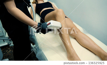 Professional beautician performing laser hair removal Professional beautician performing laser hair removal 136325925