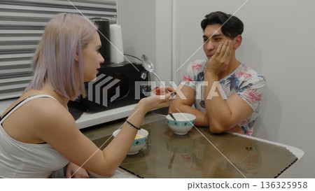 Young couple sitting and talking in a modern room Young couple sitting and talking in a modern room 136325958