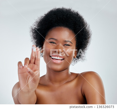 Face, hand and black woman with cream for skincare in studio isolated on a white background. Portrait, happy or African model with moisturizer, cosmetic or sunscreen for dermatology, health or beauty Face, hand and black woman with cream for skincare in studio isolated on a white background. Portrait, happy or African model with moisturizer, cosmetic or sunscreen for dermatology, health or beauty 136326073