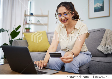 Woman, credit card and ecommerce on laptop in home for digital payment, fintech password and online shopping. Happy female customer, computer and banking code for financial bills, budget and account 136326239