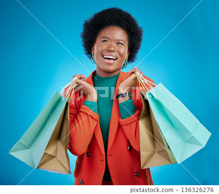 Shopping bag, thinking portrait and woman for fashion discount, giveaway wow or retail sales on blue background. Happy, excited and clothes inspiration of customer, winner or african person in studio Shopping bag, thinking portrait and woman for fashion discount, giveaway wow or retail sales on blue background. Happy, excited and clothes inspiration of customer, winner or african person in studio 136326276