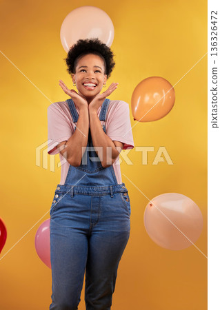 Balloons, wow and happy woman on birthday, prize or giveaway success, winning and celebration. Party, excited and young african person or gen z winner, competition or sale on yellow studio background Balloons, wow and happy woman on birthday, prize or giveaway success, winning and celebration. Party, excited and young african person or gen z winner, competition or sale on yellow studio background 136326472